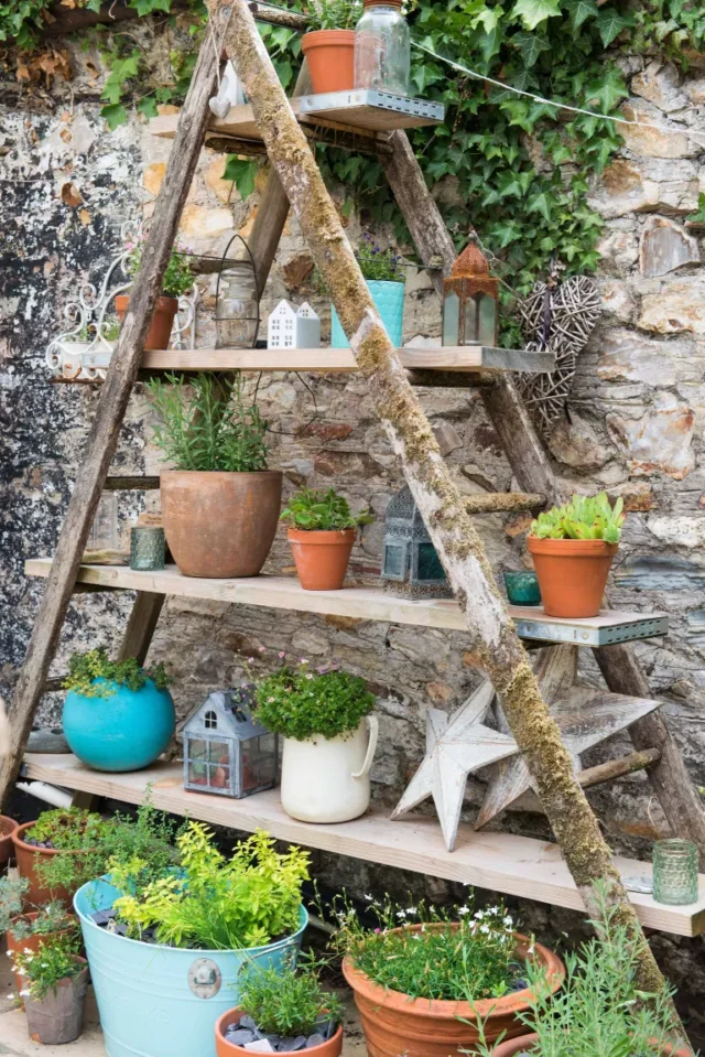 Idee per il giardinaggio nel patio: piante in vaso su telaio in legno A