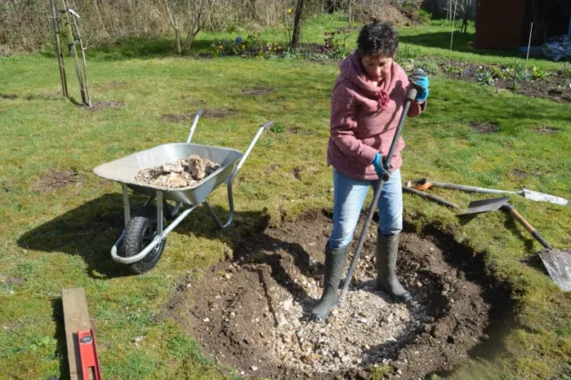 Persona che inizia a scavare un laghetto da giardino